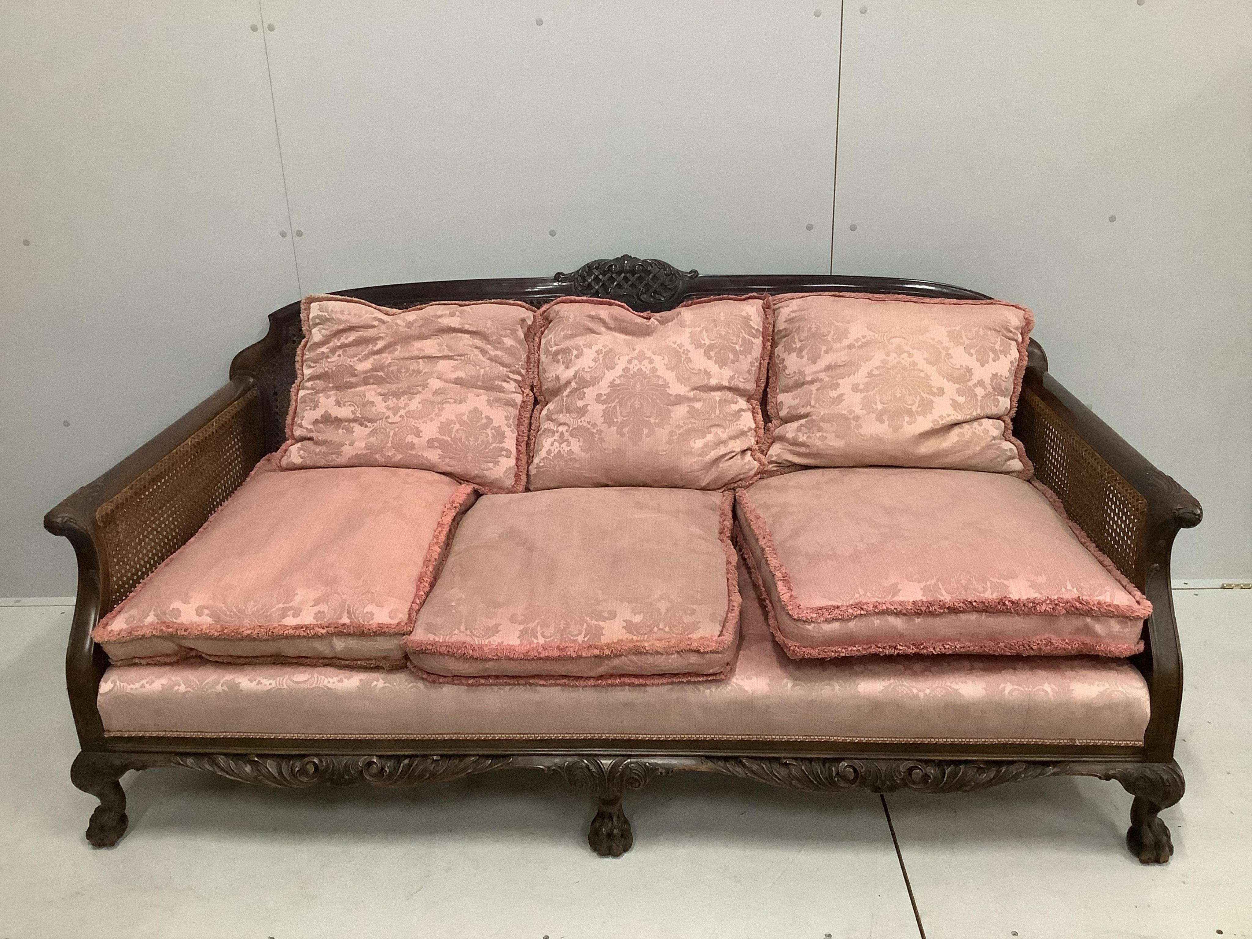 A 1930's mahogany three piece Bergere suite, with double caned arms and single caned backs. Condition - some fading with small damages to the caning